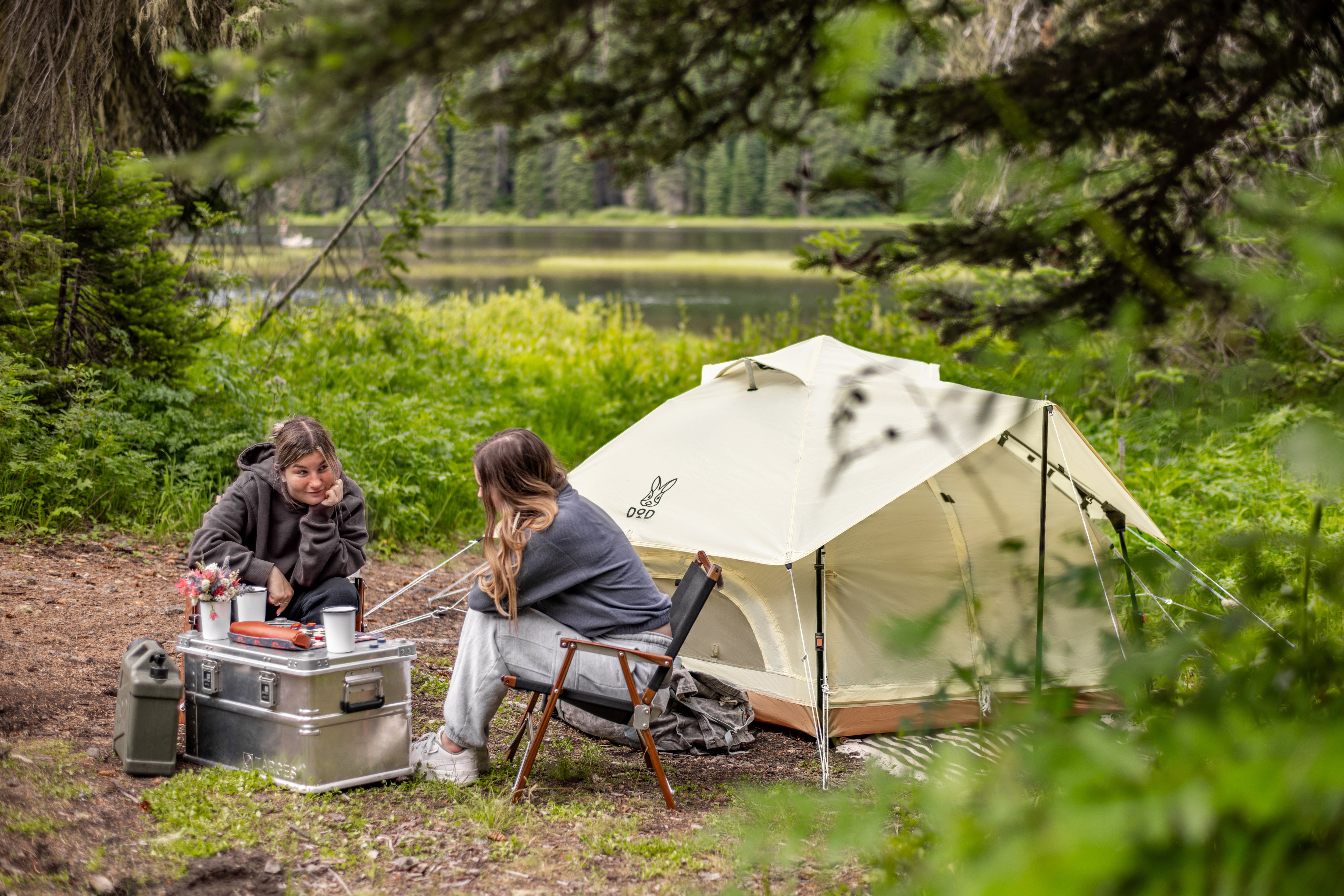 Cream-colored, canvas-style tent with a minimalist design and a small logo on the front.