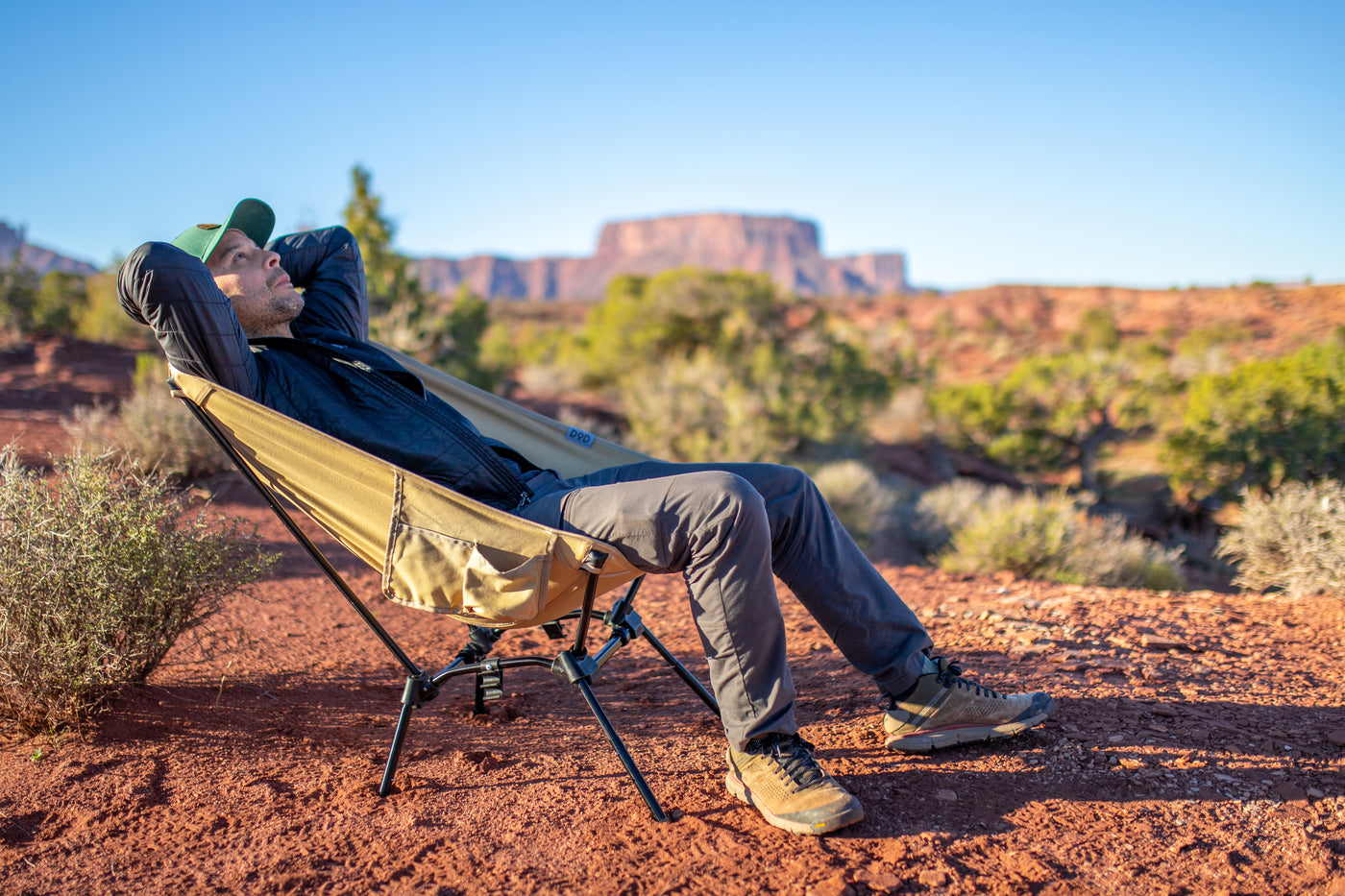 Man sitting in a camp chair outdoors.