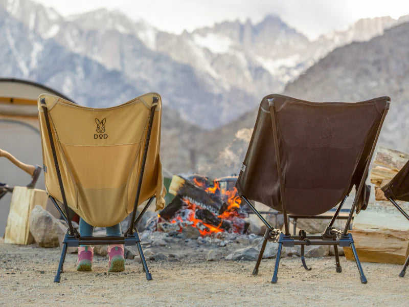 Two camping chairs by a campfire