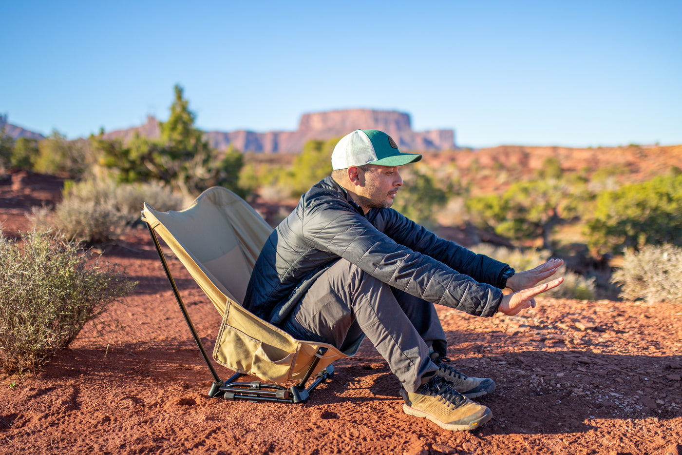 Man sitting in a camp chair outdoors.