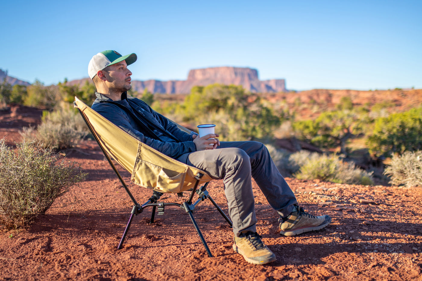 Man relaxing in a camp chair outdoors.
