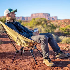 Man relaxing in a DOD camp chair.