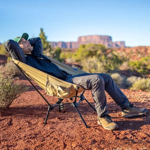 Man relaxing in a DOD camp chair.