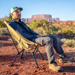 Man relaxing in a DOD camp chair.