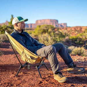 Man relaxing in a DOD camp chair.